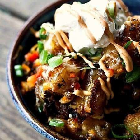Totchos Supreme {tater tots, chorizo, Cheddar, green onions, bell peppers, smoked paprika chipotle sauce, and sour cream} #Superbowl #Snacks #ComfortFood