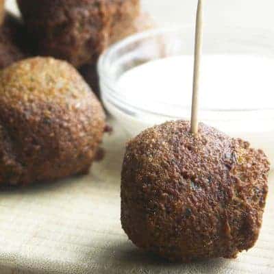 balls of fried falafel with a tahini sauce