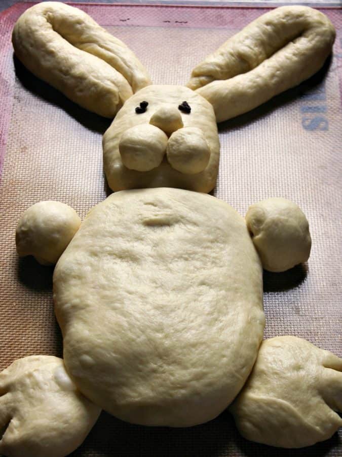 bread dough shaped like bunny on baking sheet