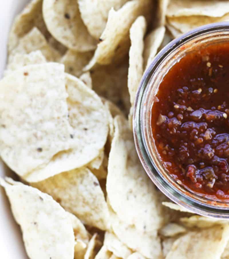 This Smoky Roasted Salsa is the little black dress of the salsa world; non-traditional, smoky, fine-textured, and slightly spicy with a bold flavour that’ll knock you out, this salsa is equally wonderful when dunked with chips, poured over meats in a slow-cooker, or spooned and baked on enchiladas. I have yet to find a commercially available salsa that matches this for depth, complexity, and utter fabulousness. I make this salsa in bulk -to the tune of a bushel each of tomatillos and plum tomatoes- every summer because the boys and their friends alike act neglected and depressed if we run out before summer rolls around. While it is far and away best when prepared in season, you can make it year ‘round in a salsa emergency. Believe me when I tell you if you run out, it will be a salsa emergency.