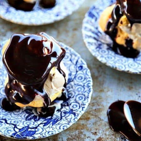 Homemade Cream Puffs filled with ice cream and topped with hot fudge sauce for profiteroles, plus a bonus tip on how to freeze choux pastry ahead of time for almost instant cream puffs!