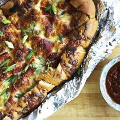 Pizza Party Bread: ooey, gooey, melted mozzarella and crispy pepperoni on buttery garlic bread that is made to be torn apart and shared by friends.