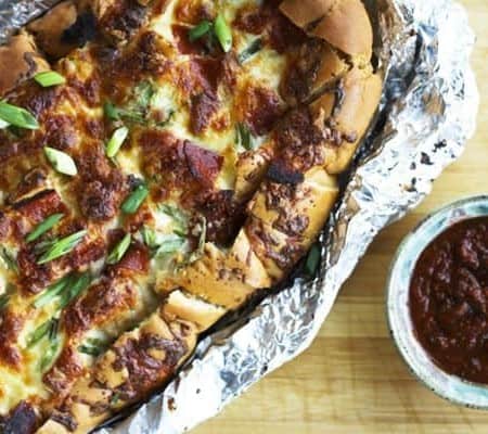 Pizza Party Bread: ooey, gooey, melted mozzarella and crispy pepperoni on buttery garlic bread that is made to be torn apart and shared by friends.