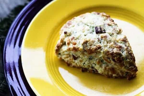 Having a bag of frozen pre-formed Bacon Cheddar Scallion Scones in the oven is your secret holiday breakfast or brunch weapon to having piping hot, tender, flaky scones studded with crispy bacon, minced scallion and tiny pockets of melted Cheddar cheese.