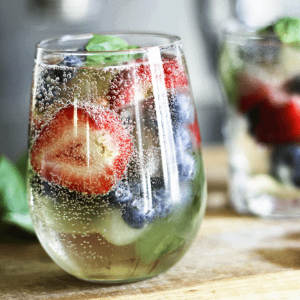 Sangria-by-the-glass makes it so you don't need to whip up a whole pitcher to enjoy Sangria! Sparkly, slightly sweet, berry-and-basil fresh!