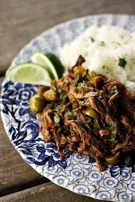 Ropa Vieja: Thin shreds of flank steak braised in a rich tomato vegetable sauce with olives &capers. Prepare in an Instant Pot OR Slow-Cooker.