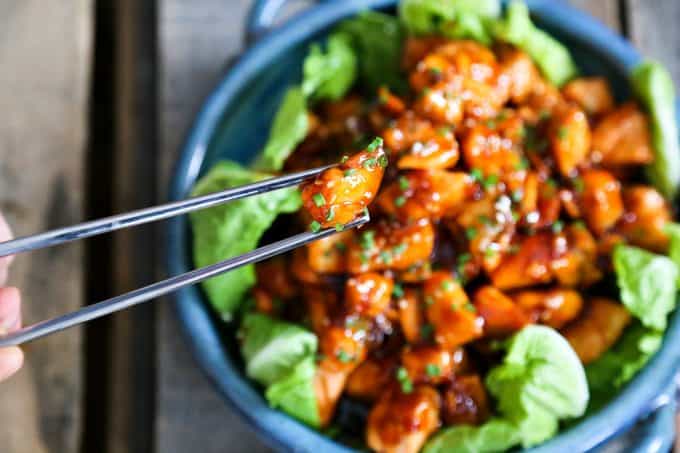 Honey Sriracha Glazed Salmon Bites: Tender salmon tossed in a sticky, sweet, spicy mahogany sauce. Serve in lettuce wraps, or on hot rice.