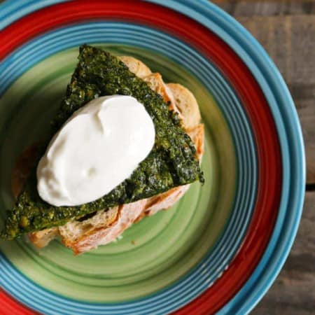 Plain yogurt garnishing Persian Herb Frittata a.k.a. Kookoo Sabzi from foodiewithfamily.com