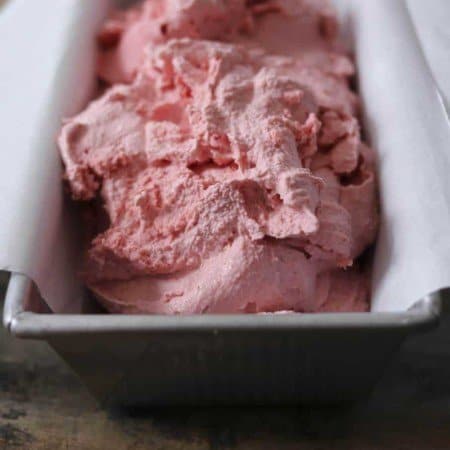 3-ingredient strawberry ice cream, parchment paper lined aluminum bread pan, rustic wooden table