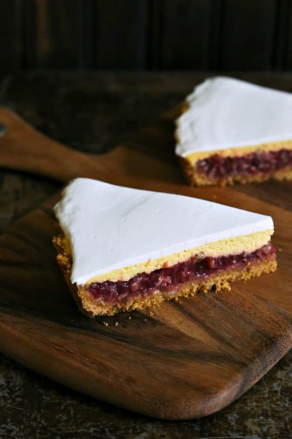 Rhubarb Custard Pie starts with a simple crumb crust that is filled with a tart and sweet rhubarb vanilla filling covered by thin layer of cheesecake and topped with a smooth-as-silk tangy yogurt layer. It's spring and summer perfection, folks.