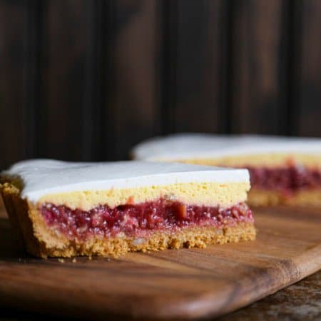 Rhubarb Custard Pie starts with a simple crumb crust that is filled with a tart and sweet rhubarb vanilla filling covered by thin layer of cheesecake and topped with a smooth-as-silk tangy yogurt layer. It's spring and summer perfection, folks.