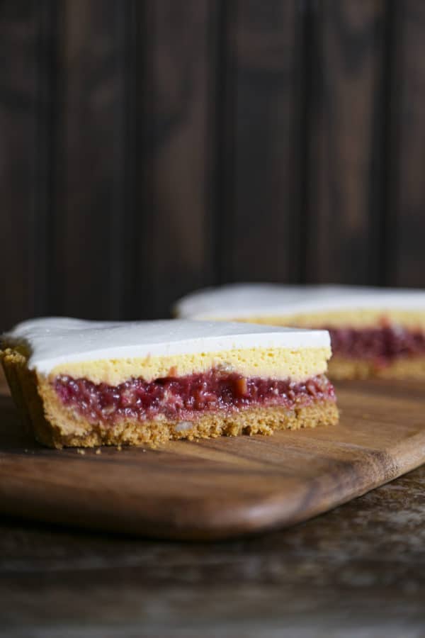 Rhubarb Custard Pie starts with a simple crumb crust that is filled with a tart and sweet rhubarb vanilla filling covered by thin layer of cheesecake and topped with a smooth-as-silk tangy yogurt layer. It's spring and summer perfection, folks.