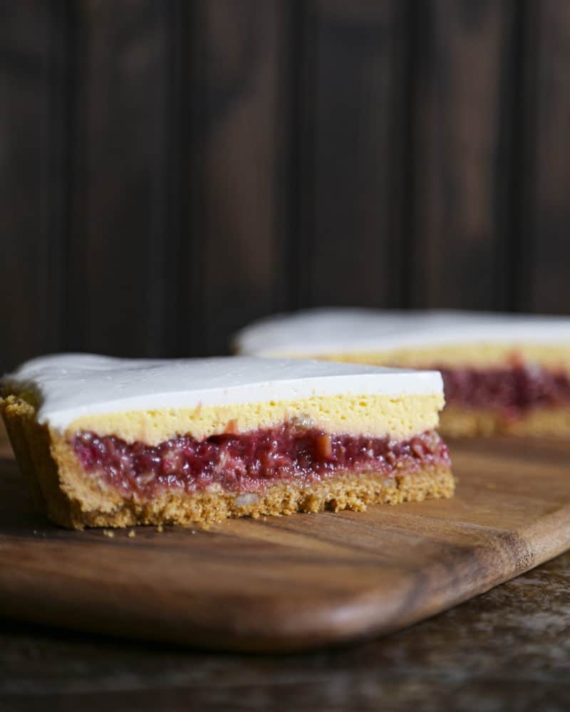 Rhubarb Custard Pie starts with a simple crumb crust that is filled with a tart and sweet rhubarb vanilla filling covered by thin layer of cheesecake and topped with a smooth-as-silk tangy yogurt layer. It's spring and summer perfection, folks.