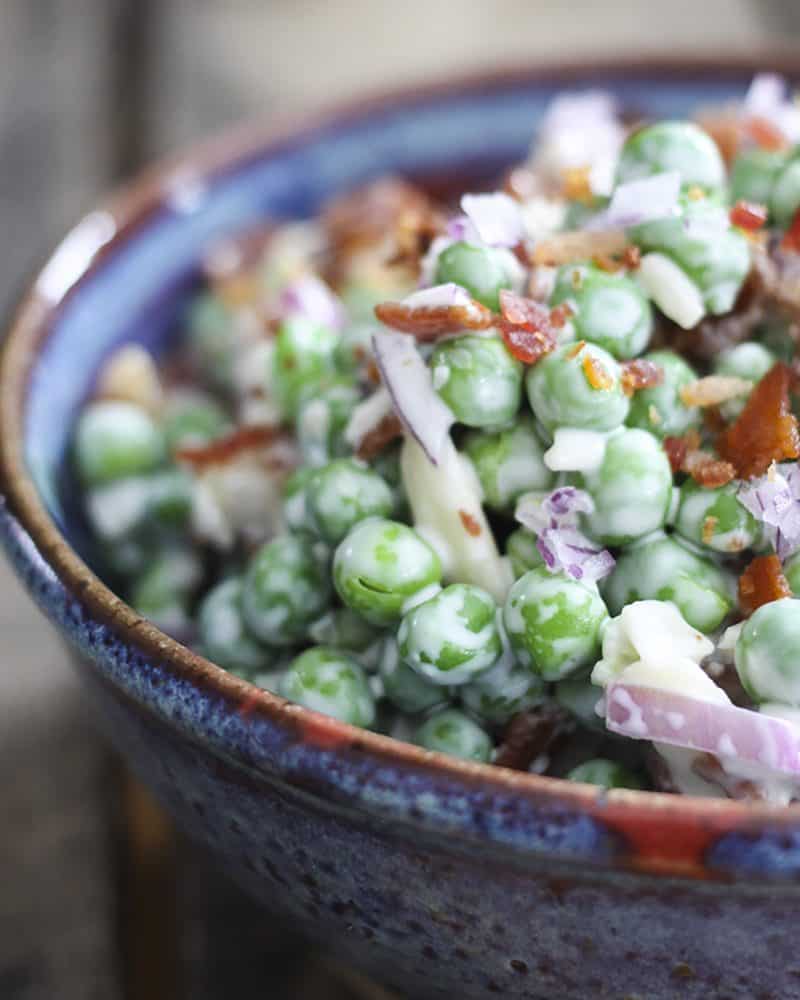 Easy Bacon Pea Salad: It doesn't get much easier or tastier than this cold salad of peas, crispy bacon, crunchy red onions, and creamy dressing. Serve with grilled or roasted chicken, pork, fish, or even ham!