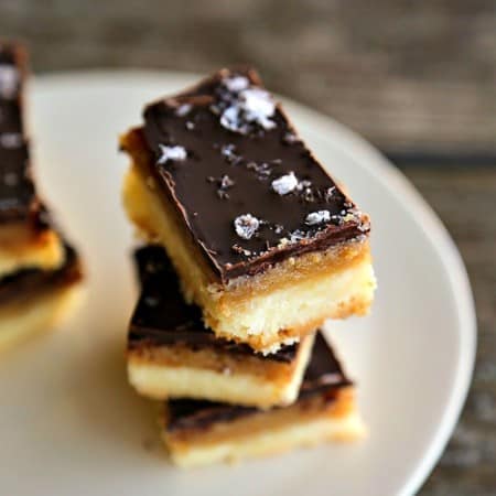 Selfish Bars - Chocolate Caramel Sugar Cookie Bars, shortbread, caramel, melted chocolate, maldon sea salt on white ceramic plate, wooden backgroundThese are worth being selfish over!