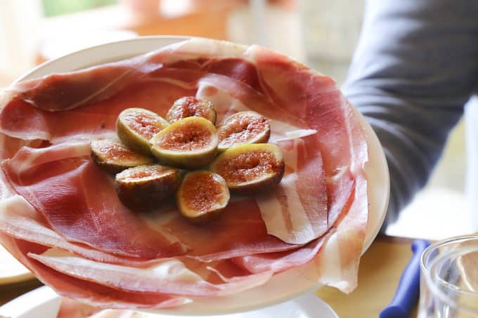 Prosciutto made at Macelleria Falaschi served at Falaschi's butcher shop in San Minianto. foodiewithfamily.com and figs served by