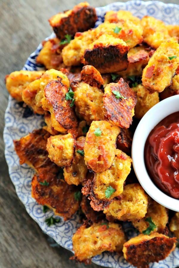 Baked, crispy, Bacon Cheddar Cauliflower Tots {Healthier Tater Tots} are the ultimate in crispy, cheesy perfection. You'd never know they're lower carb than tater tots and honestly, you'd be hard pressed to know they're NOT tater tots. 
