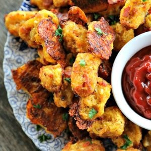 Baked, crispy, Bacon Cheddar Cauliflower Tots {Healthier Tater Tots} are the ultimate in crispy, cheesy perfection. You'd never know they're lower carb than tater tots and honestly, you'd be hard pressed to know they're NOT tater tots.