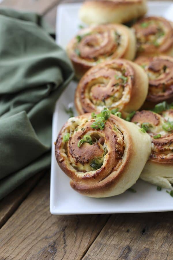 Hot Ham Cheese Rolls: the best bread dough wrapped around smoky ham, piles of Cheddar cheese, and green onions, sliced, and baked to tender perfection.