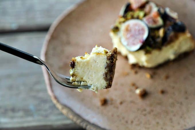 Ultra-creamy, not too sweet, and a feast-for-the-eyes while still being simple to make, this vanilla bean flecked Fig Pistachio Honey Goat Cheese Cheesecake is a show stopper!