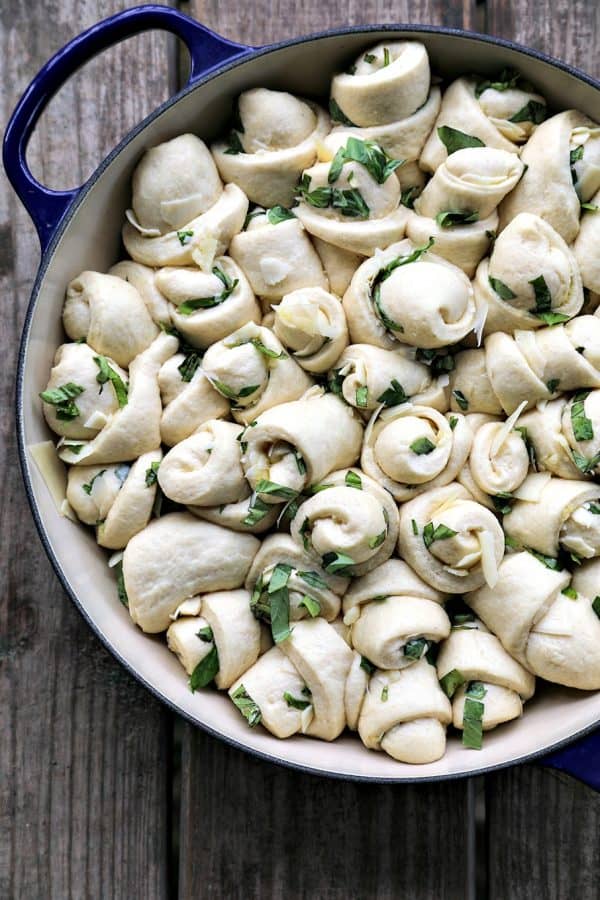 Garlic Basil Parmesan Rolls are my idea of a perfect bread. Perfect bread dough brushed with garlic infused olive oil and rolled around chopped garlic, fresh basil, and flakes of creamy, nutty Parmesan cheese then baked up to a beautiful, golden brown, tender-yet-chewy work of art.