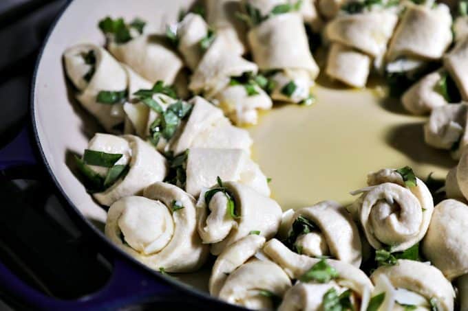 Garlic Basil Parmesan Rolls are my idea of a perfect bread. Perfect bread dough brushed with garlic infused olive oil and rolled around chopped garlic, fresh basil, and flakes of creamy, nutty Parmesan cheese then baked up to a beautiful, golden brown, tender-yet-chewy work of art.