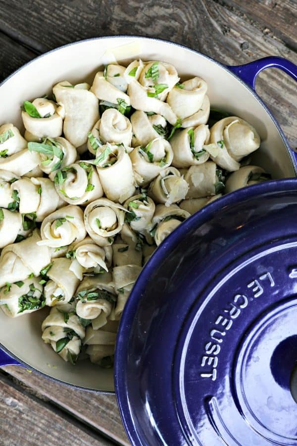 Garlic Basil Parmesan Rolls are my idea of a perfect bread. Perfect bread dough brushed with garlic infused olive oil and rolled around chopped garlic, fresh basil, and flakes of creamy, nutty Parmesan cheese then baked up to a beautiful, golden brown, tender-yet-chewy work of art.