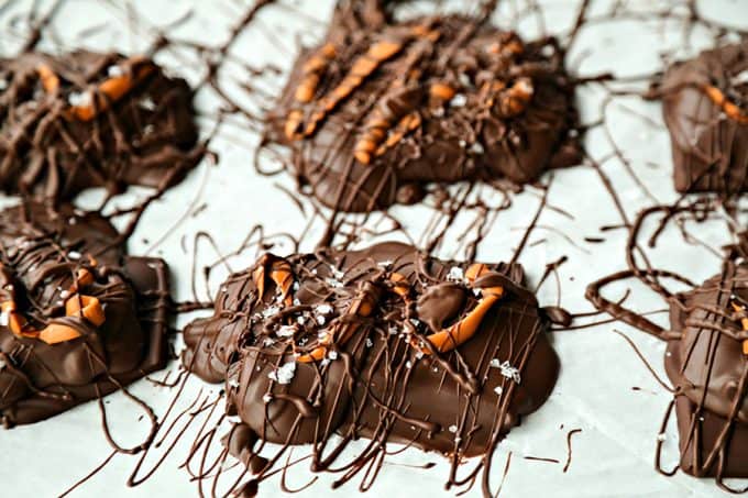 Chocolate Covered Caramel Stuffed Pretzels; crunchy sourdough pretzels enrobed in dark chocolate with a sprinkling of flaky sea salt that ooze perfectly gooey caramel when you bite into them.