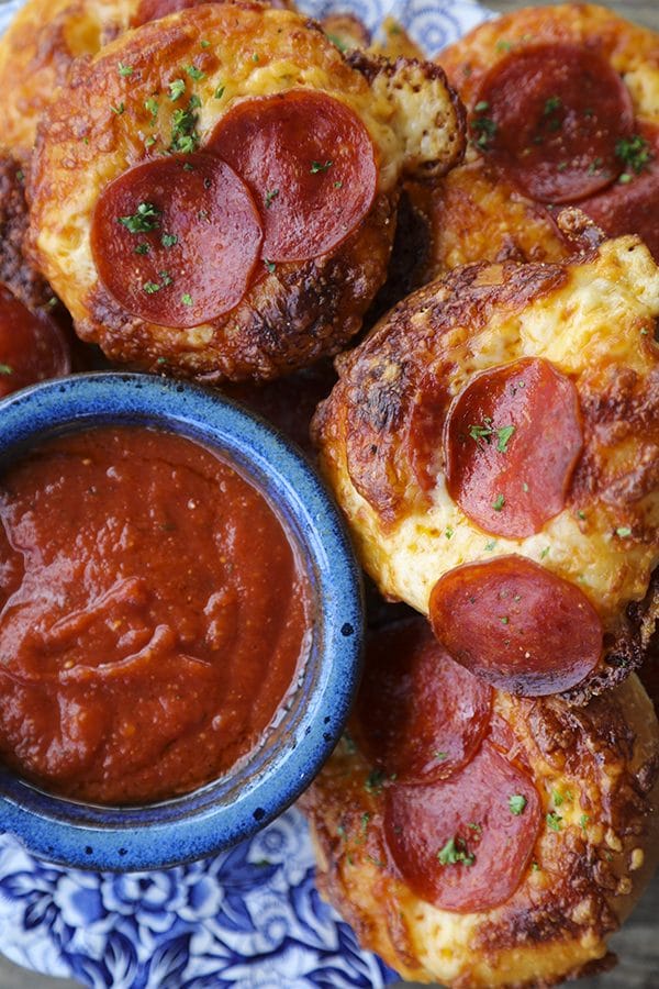 Pepperoni Pizza Bialys Recipe: fresh-from-the-oven, chewy, bagel-like bread topped with chopped garlic, the barest hint of pizza sauce and olive oil, a generous cap of melted cheese, and a couple of crispy-edged pepperoni to crown it.