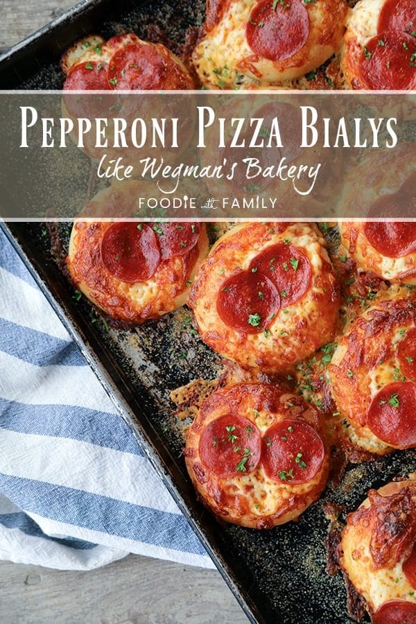 Pepperoni Pizza Bialys Recipe: fresh-from-the-oven, chewy, bagel-like bread topped with chopped garlic, the barest hint of pizza sauce and olive oil, a generous cap of melted cheese, and a couple of crispy-edged pepperoni to crown it.