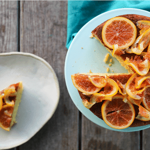 Orange Olive Oil Cake with Candied Oranges is light, has a fine crumb, is perfectly moist but not sopping, is beautifully fragrant of oranges, has just a hint of warm cardamom, and is festooned with thin slices of orange lovingly candied in honey and cardamom syrup.