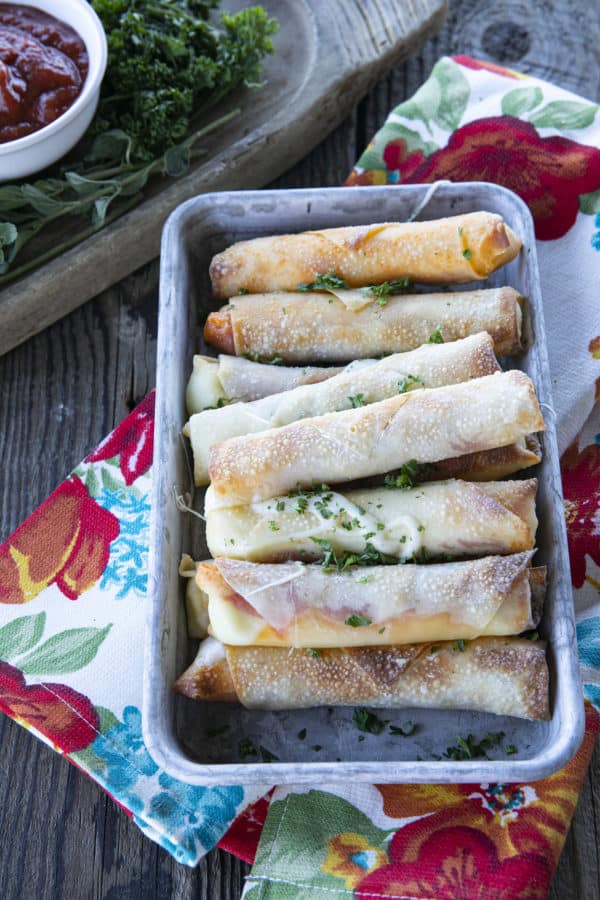Pizza Logs are crispy, crunchy egg rolls filled with gooey, melted mozzarella cheese and garlicky pepperoni. Whether you whip these up in your air fryer, oven, or in a frying pan, you'll want these not just for game day, but all the time!
