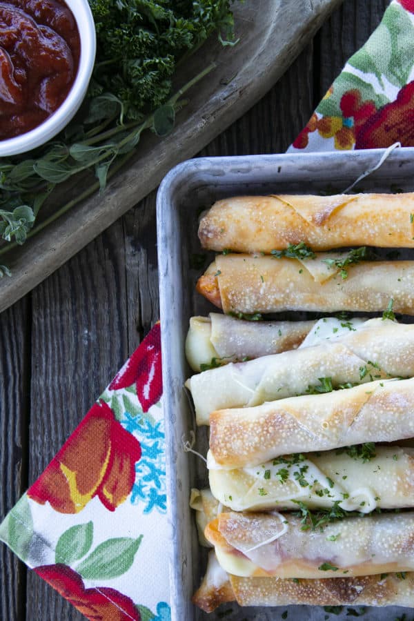 Pizza Logs are crispy, crunchy egg rolls filled with gooey, melted mozzarella cheese and garlicky pepperoni. Whether you whip these up in your air fryer, oven, or in a frying pan, you'll want these not just for game day, but all the time!