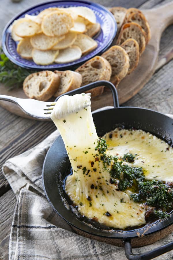 Provoleta -or Fried Cheese- is a delicious Argentinian cheese dish of pan-fried provolone cheese with crushed red pepper flakes and delicious garlic and herb chimichurri. An easier and more enticing appetizer simply doesn't exist!