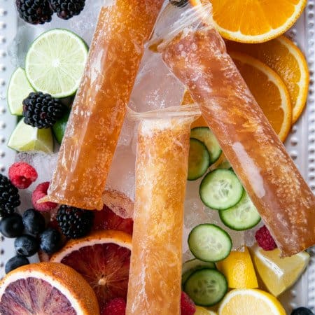Pimm's Cup Recipe boozy popsicles are made of a gin-based liqueur, fizzy Prosecco, a hint of lemon and strawberry puree, and are guaranteed to refresh you!