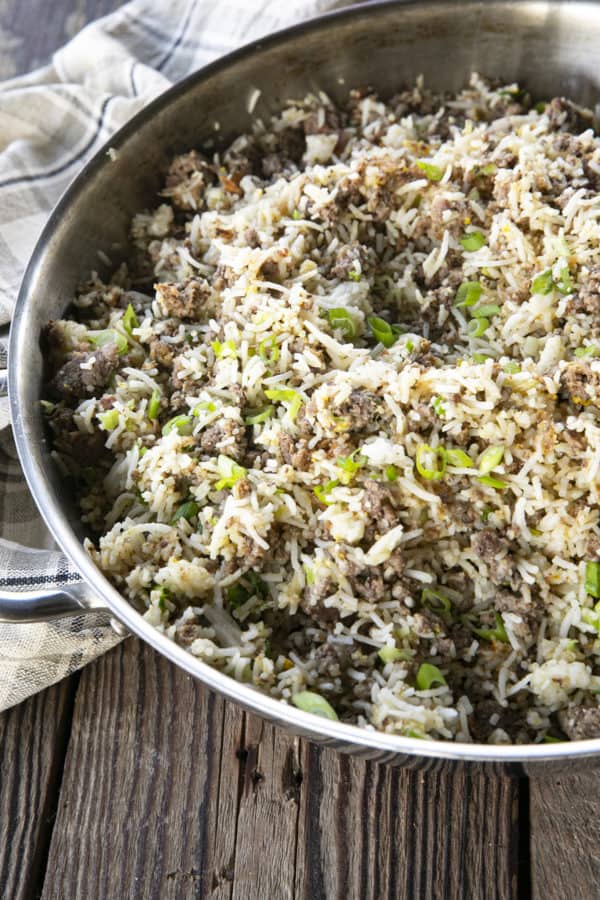 Ground Beef Fried Rice in a pan on a wooden table.