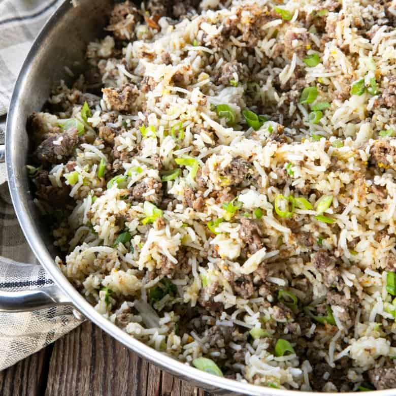 Ground Beef Fried Rice in a pan on a wooden table.