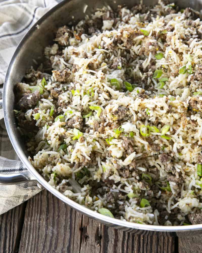 Ground Beef Fried Rice in a pan on a wooden table.