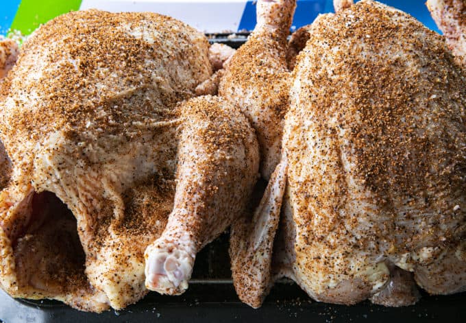 Two whole chickens dry rubbed to make smoked whole chicken.