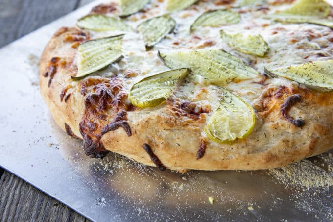 reamy garlic dill sauce, molten cheese, and a scandalous amount of garlicky dill pickles make this Pickle Pizza a memorable, delicious, and habit forming departure from your average pizza. Make with homemade pizza dough or store-bought dough, but do make it!