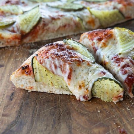 reamy garlic dill sauce, molten cheese, and a scandalous amount of garlicky dill pickles make this Pickle Pizza a memorable, delicious, and habit forming departure from your average pizza. Make with homemade pizza dough or store-bought dough, but do make it!