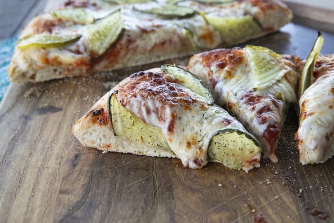 reamy garlic dill sauce, molten cheese, and a scandalous amount of garlicky dill pickles make this Pickle Pizza a memorable, delicious, and habit forming departure from your average pizza. Make with homemade pizza dough or store-bought dough, but do make it!