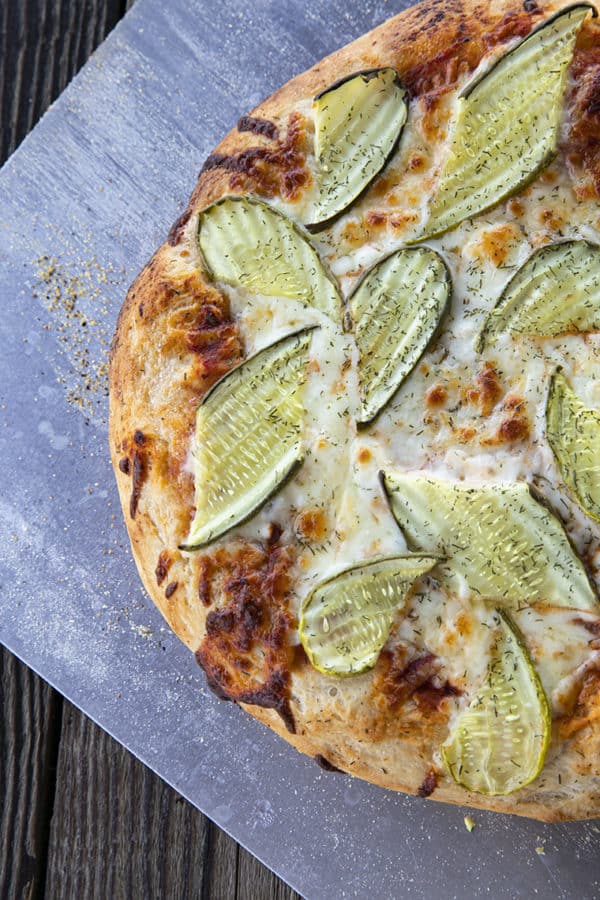 reamy garlic dill sauce, molten cheese, and a scandalous amount of garlicky dill pickles make this Pickle Pizza a memorable, delicious, and habit forming departure from your average pizza. Make with homemade pizza dough or store-bought dough, but do make it!