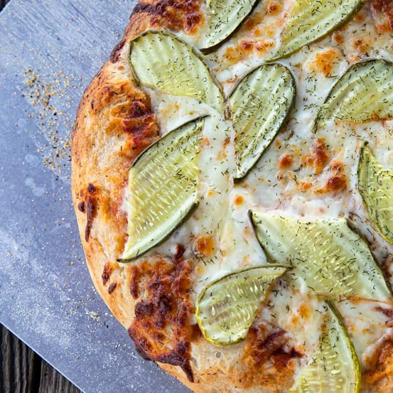 reamy garlic dill sauce, molten cheese, and a scandalous amount of garlicky dill pickles make this Pickle Pizza a memorable, delicious, and habit forming departure from your average pizza. Make with homemade pizza dough or store-bought dough, but do make it!