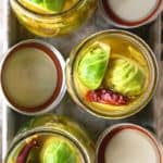 Pickled Brussels Sprouts are garlicky, tangy, crisp-tender, pickled orbs that are delicious as a snack or on a charcuterie board.