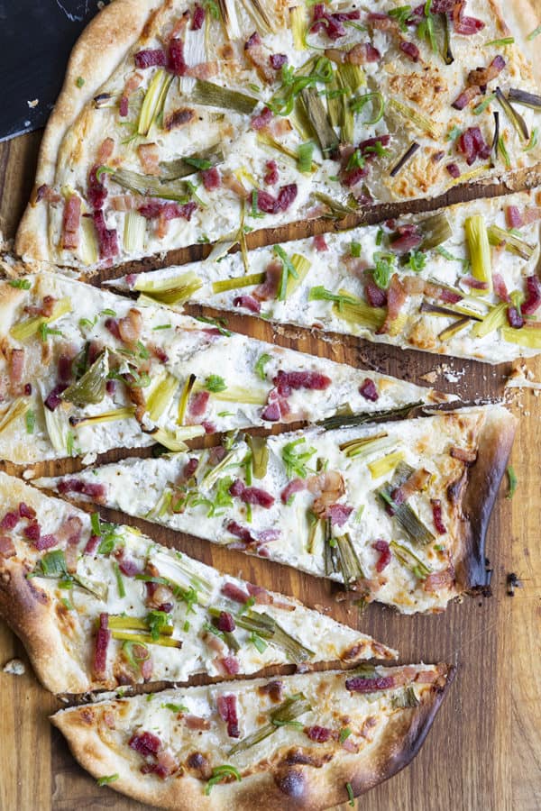 Flammekueche, tarte Flambée, or flammkuchen is a fast and easy bacon and onion pizza type flatbread made with crème fraîche or sour cream. No yeast needed!