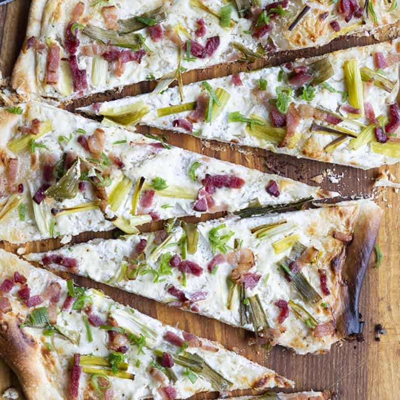 Flammekueche, tarte Flambée, or flammkuchen is a fast and easy bacon and onion pizza type flatbread made with crème fraîche or sour cream. No yeast needed!