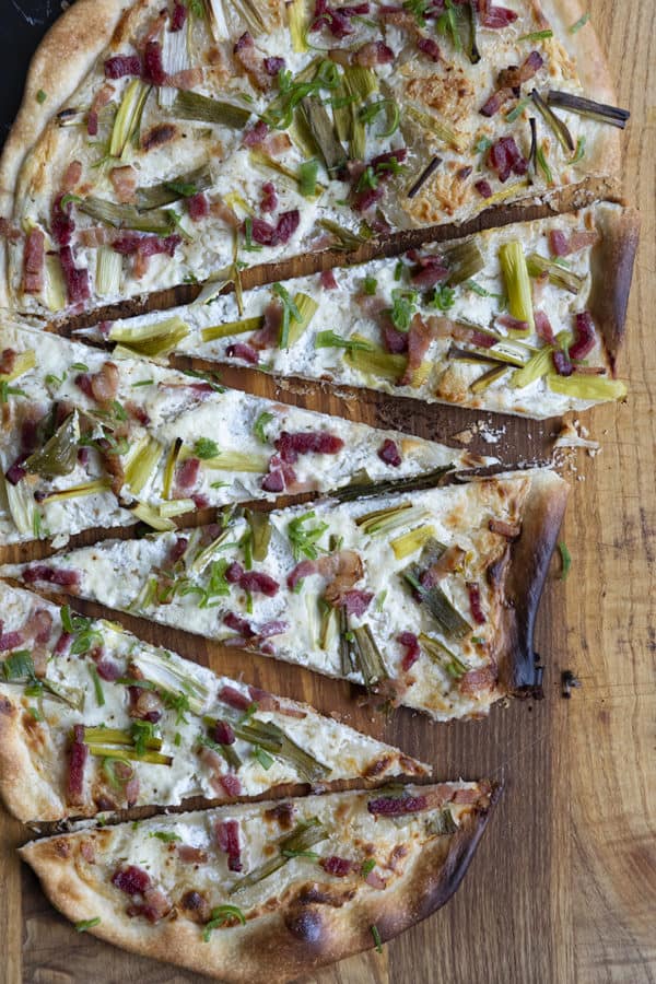 Flammekueche, tarte Flambée, or flammkuchen is a fast and easy bacon and onion pizza type flatbread made with crème fraîche or sour cream. No yeast needed!