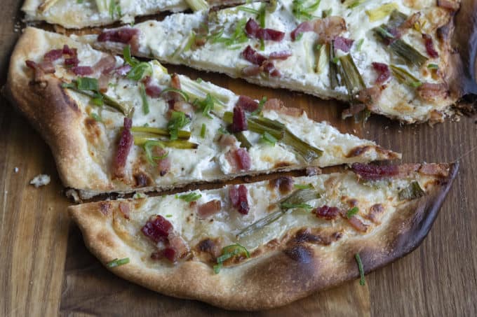 Flammekueche, tarte Flambée, or flammkuchen is a fast and easy bacon and onion pizza type flatbread made with crème fraîche or sour cream. No yeast needed!