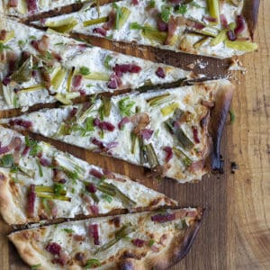 Flammekueche, tarte Flambée, or flammkuchen is a fast and easy bacon and onion pizza type flatbread made with crème fraîche or sour cream. No yeast needed!